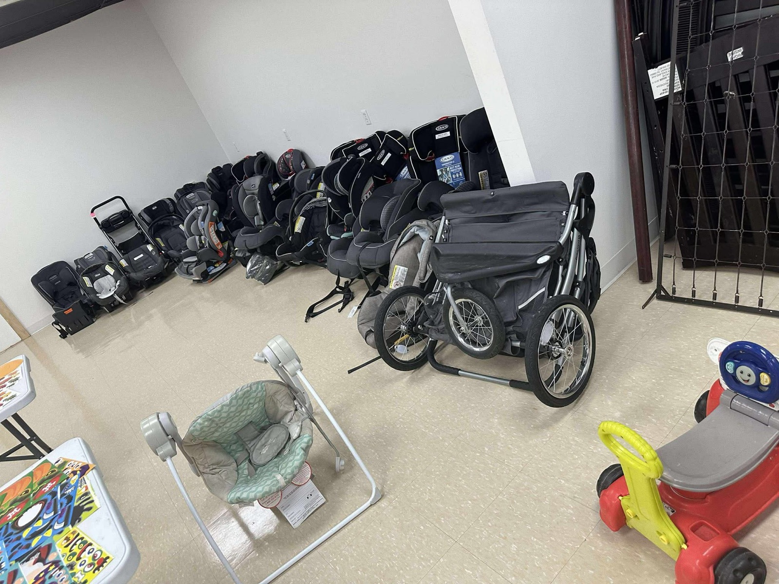Donated strollers, an infant seat, and baby gear gathered for families in need